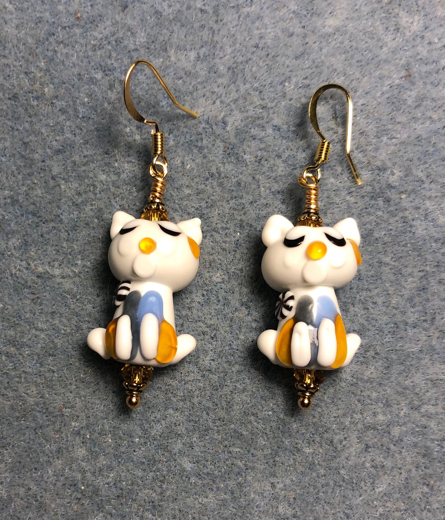 White, light blue, and amber lamp work cat bead earrings adorned with amber Chinese crystal beads.
