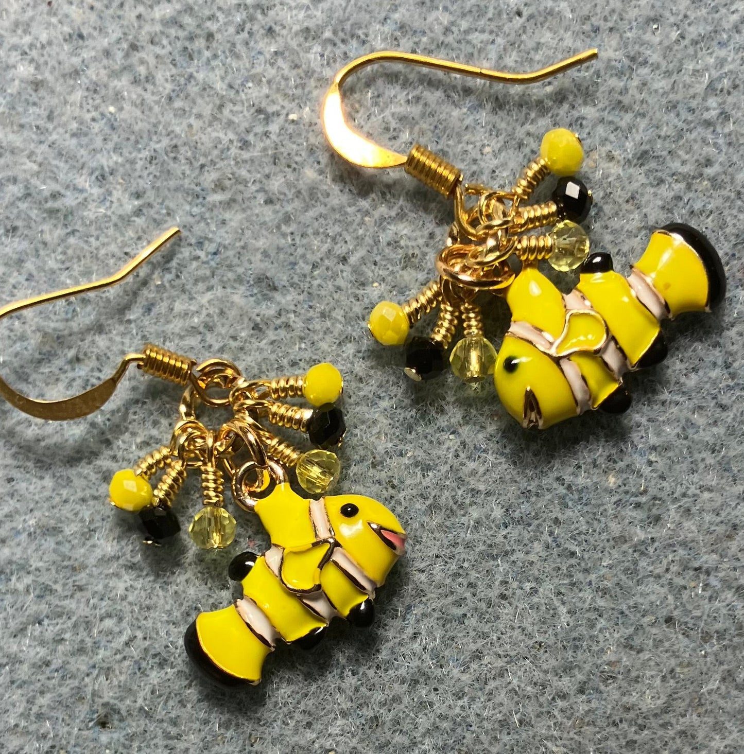 Small yellow and black enamel striped fish charm earrings adorned with tiny dangling yellow and black Chinese crystal beads.