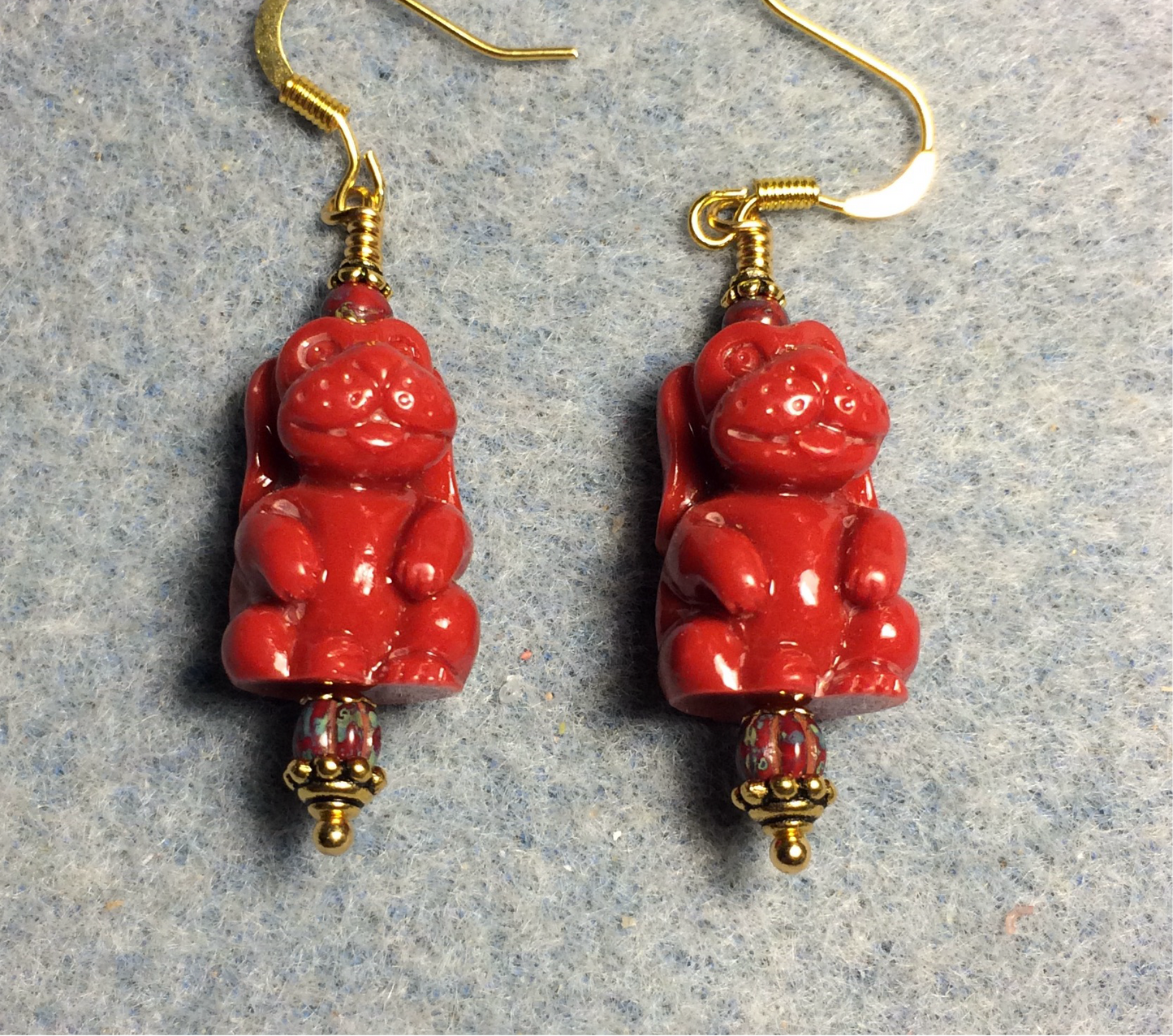 Bright red resin puppy dog bead earrings adorned with red Picasso Czech glass beads.