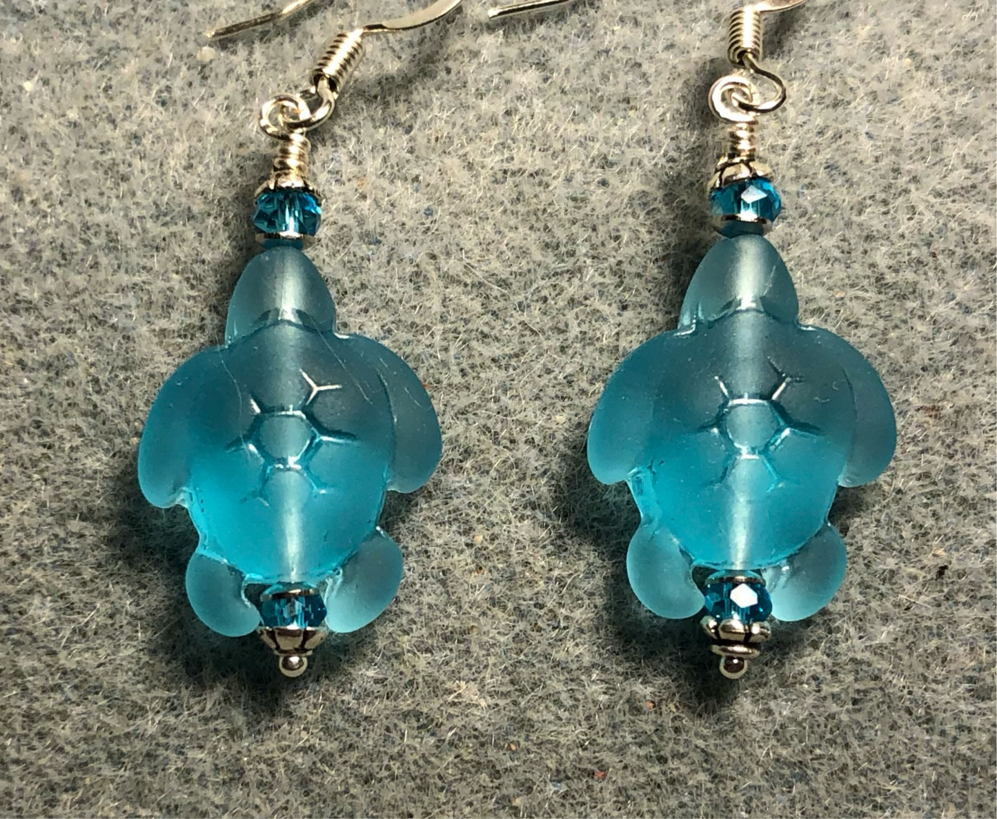 Turquoise sea glass sea turtle bead earrings adorned with turquoise Chinese crystal beads.