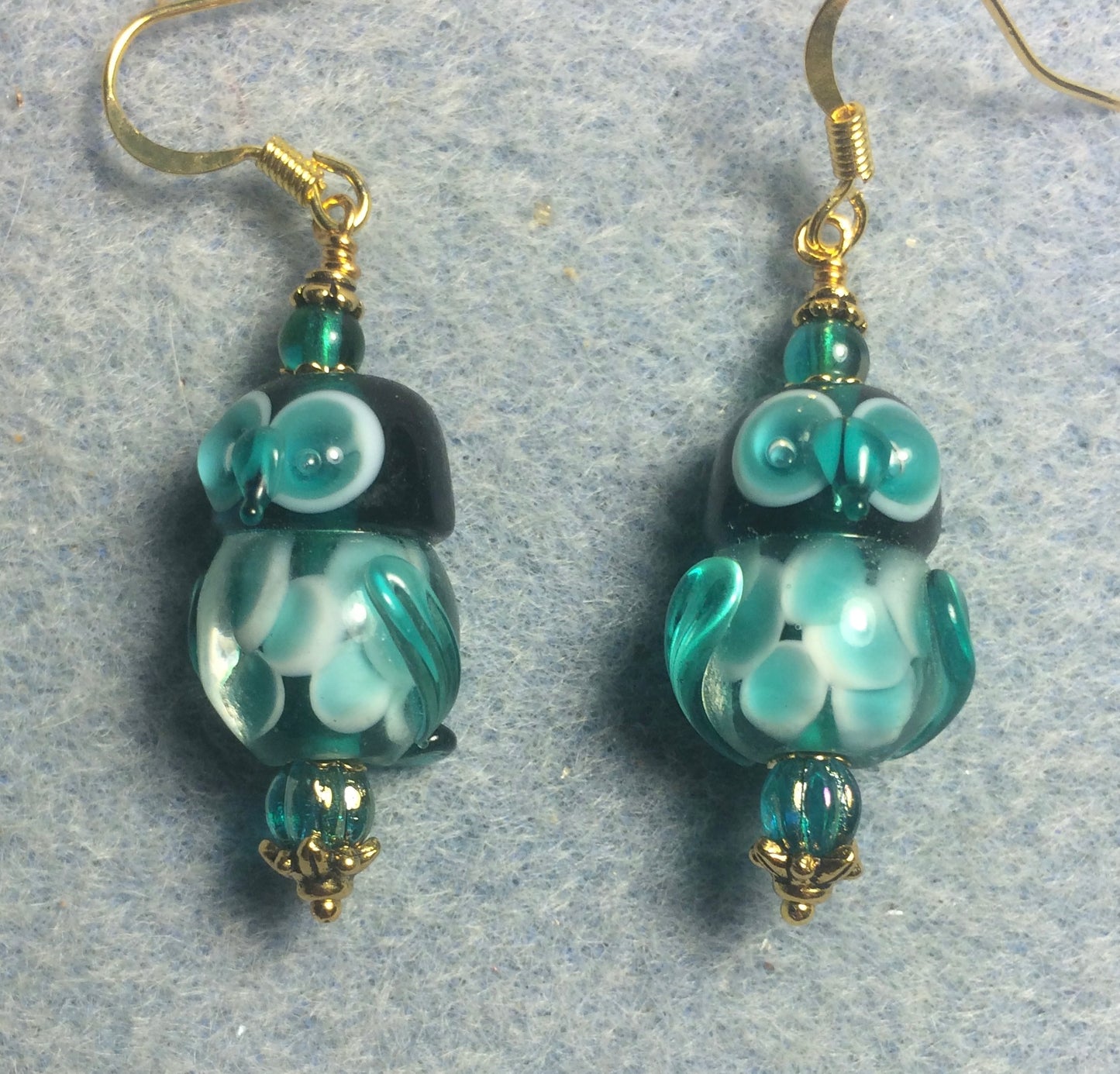 Teal lamp work owl bead earrings adorned with teal Czech glass beads.