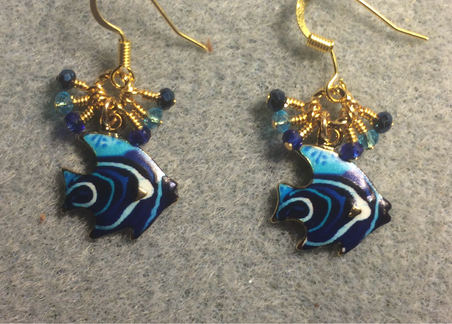 Dark blue and turquoise enamel striped angelfish charm earrings adorned with tiny dangling dark blue and turquoise Chinese crystal beads.