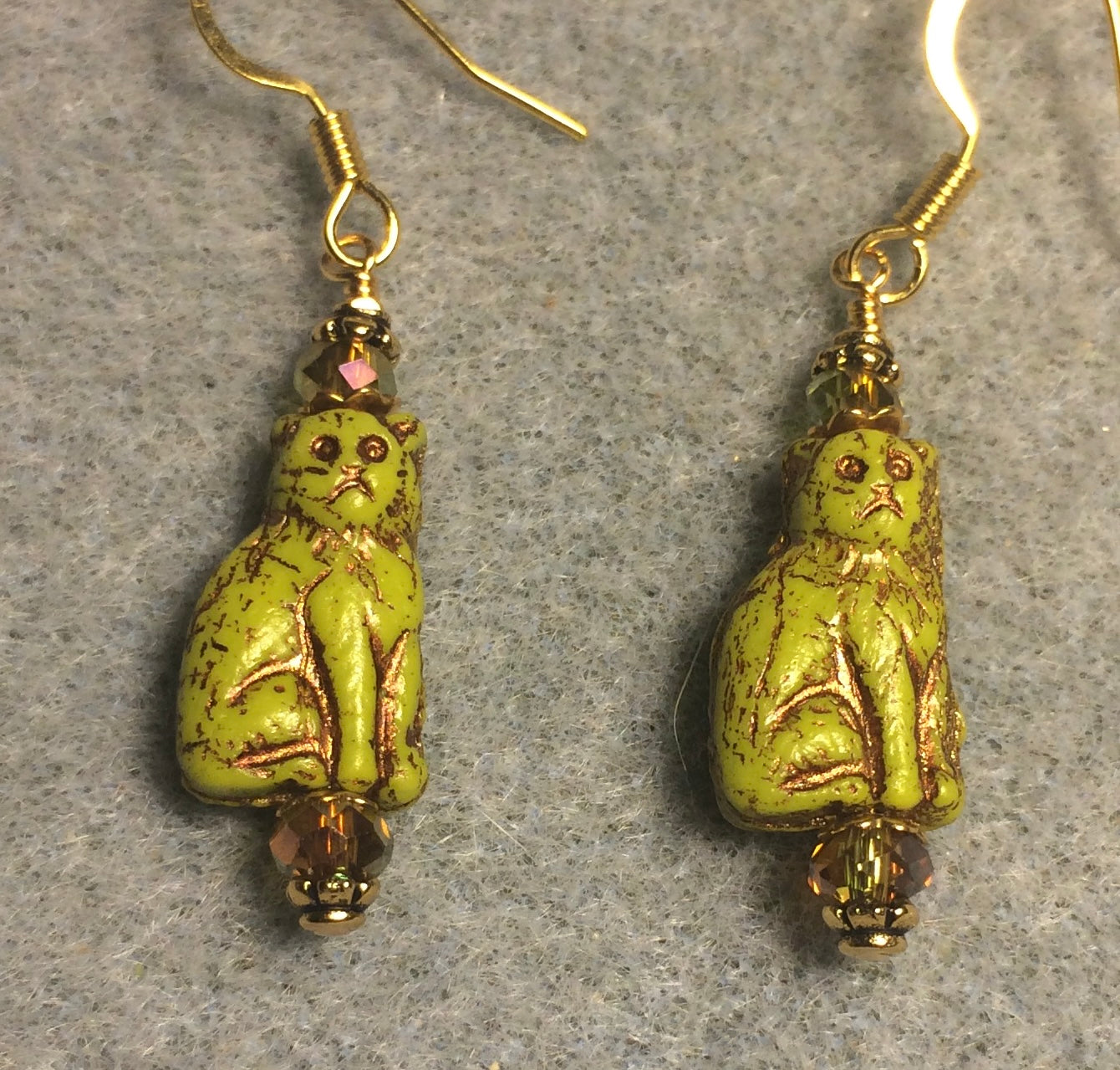 Small opaque chartreuse Czech glass cat bead earrings adorned with sparkly olive green Chinese crystal beads.