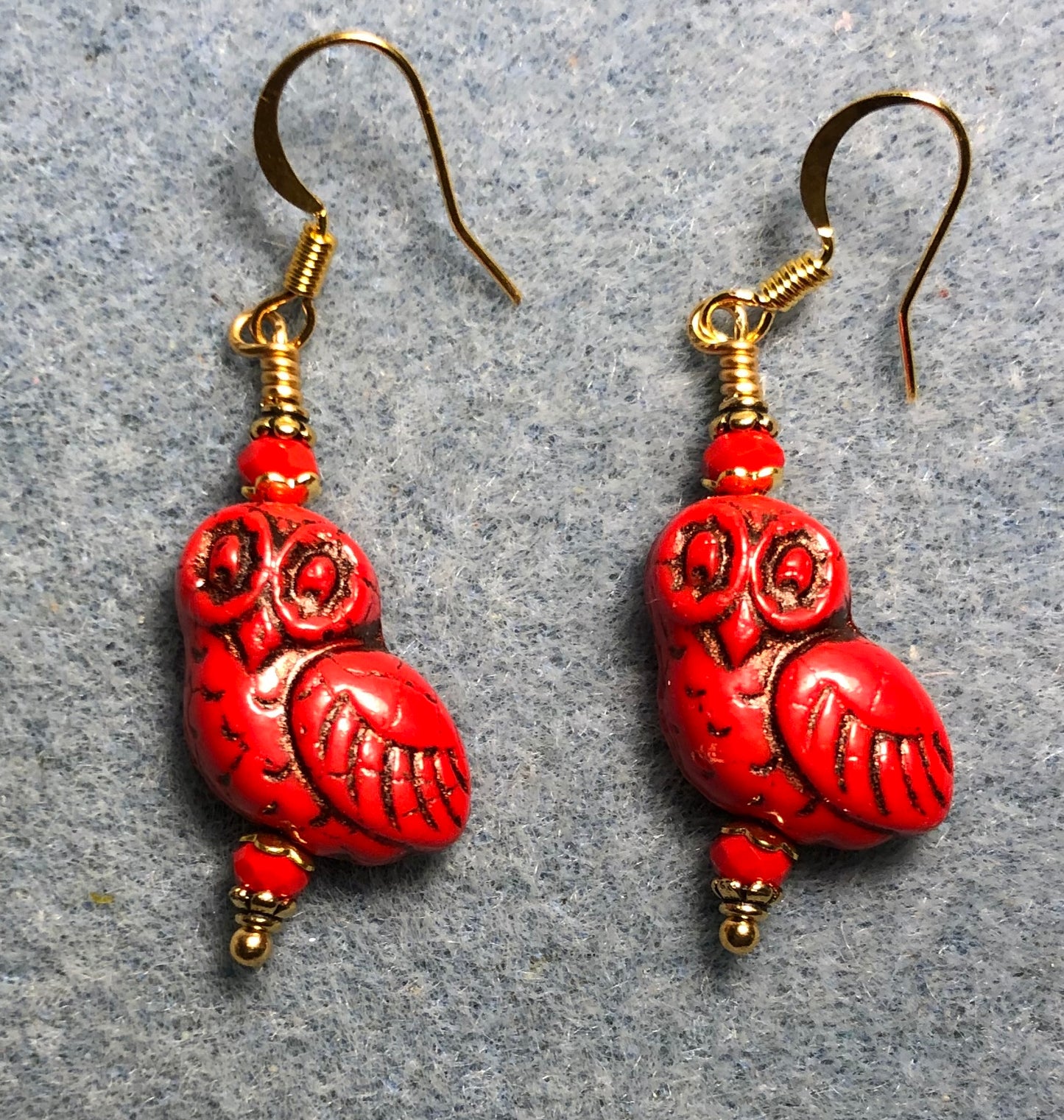 Opaque red (with black wash) fancy Czech glass owl bead earrings adorned with opaque red Chinese crystal beads.