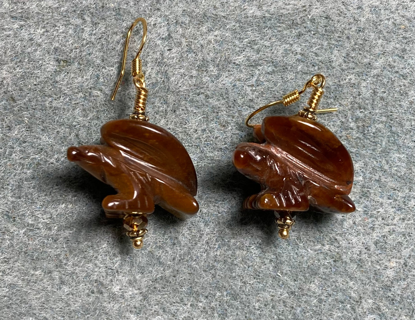 Large brown tigereye gemstone eagle bead earrings adorned with brown Chinese crystal beads.
