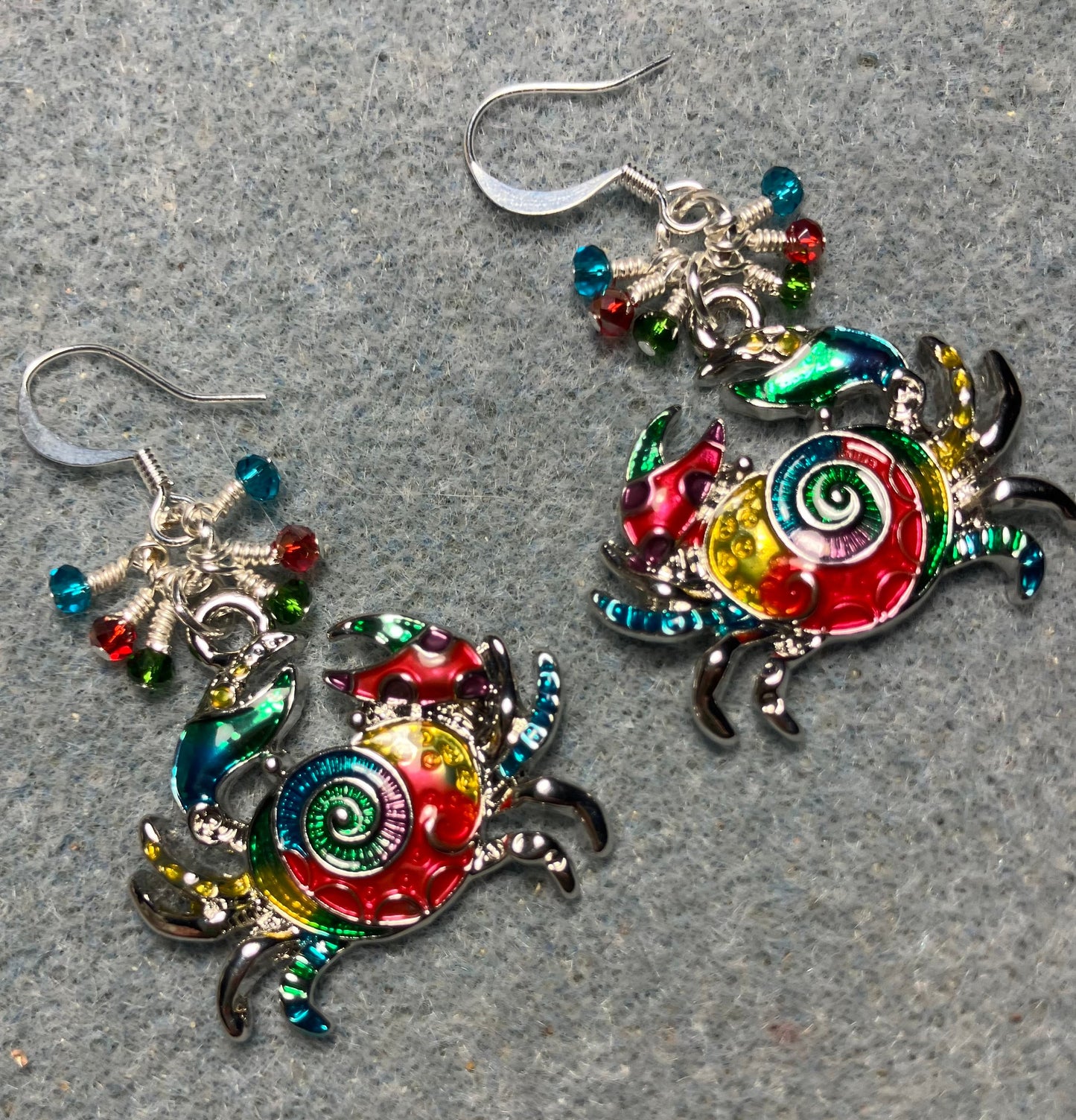 Silver and multicolored enamel crab charm earrings adorned with tiny dangling turquoise, red, and green Chinese crystal beads.