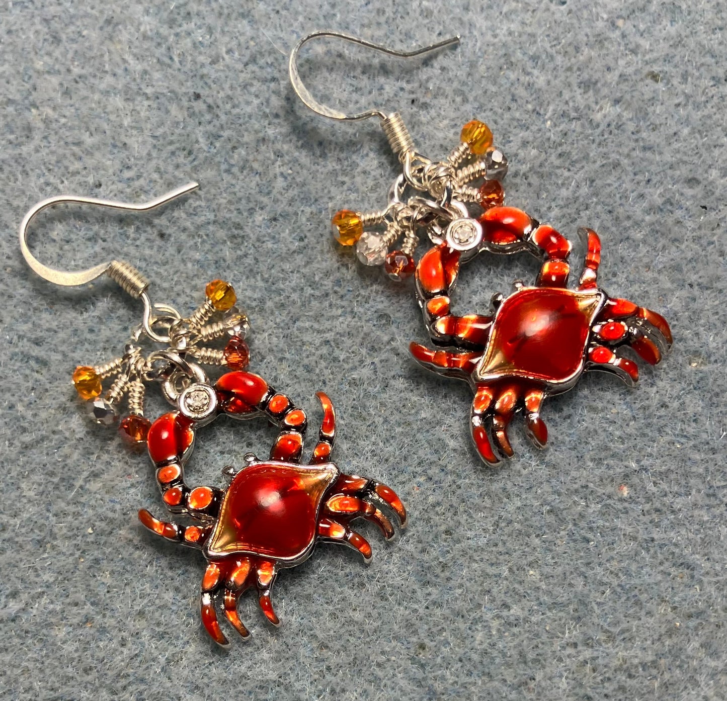 Dark orange enamel crab charm earrings adorned with tiny dangling dark orange, light orange, and silver Chinese crystal beads.