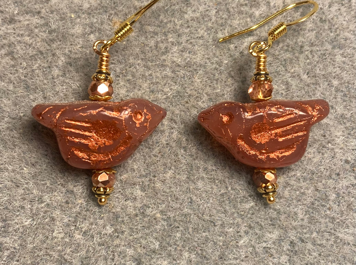 Orange (with copper wash) Czech glass bird bead earrings adorned with gold Chinese crystal beads.