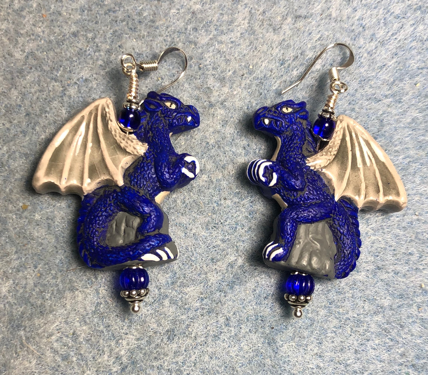 Large dark blue dragon bead earrings adorned with dark blue Czech glass beads.