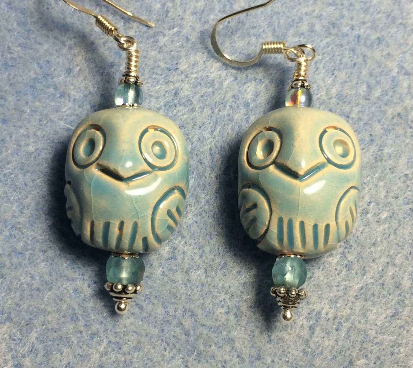 Light blue ceramic owl bead earrings adorned with light blue Czech glass beads.