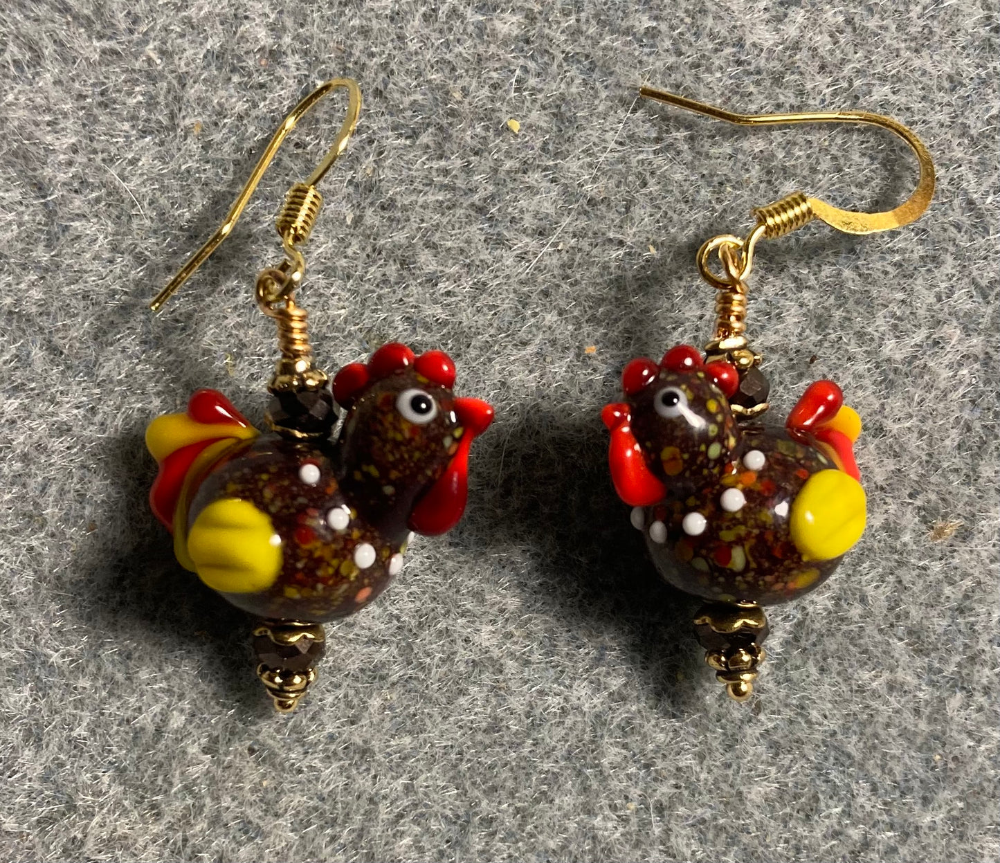 Small brown and yellow lamp work chicken bead earrings adorned with brown Chinese crystal beads.