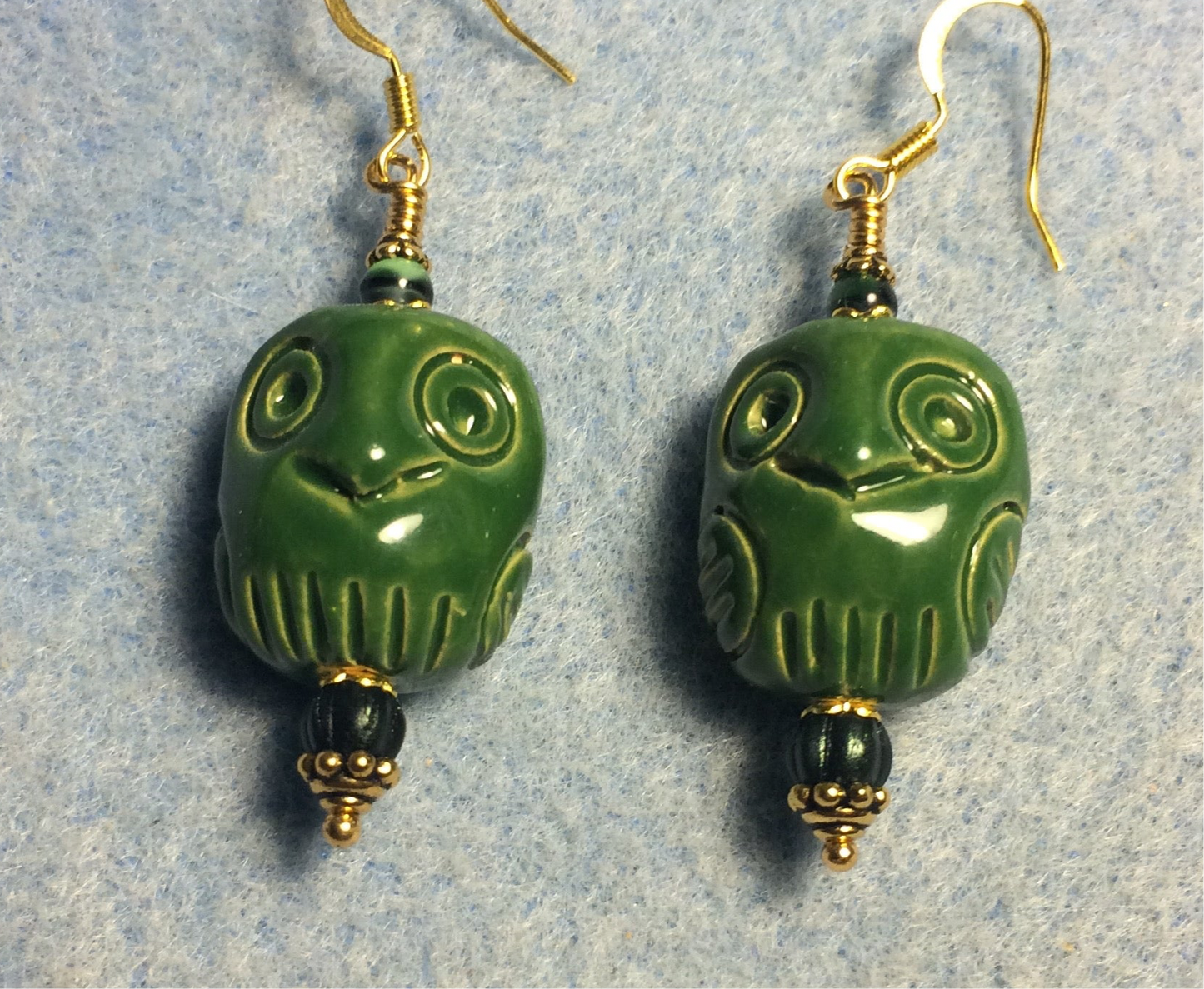 Dark green ceramic owl bead earrings adorned with dark green Czech glass beads.
