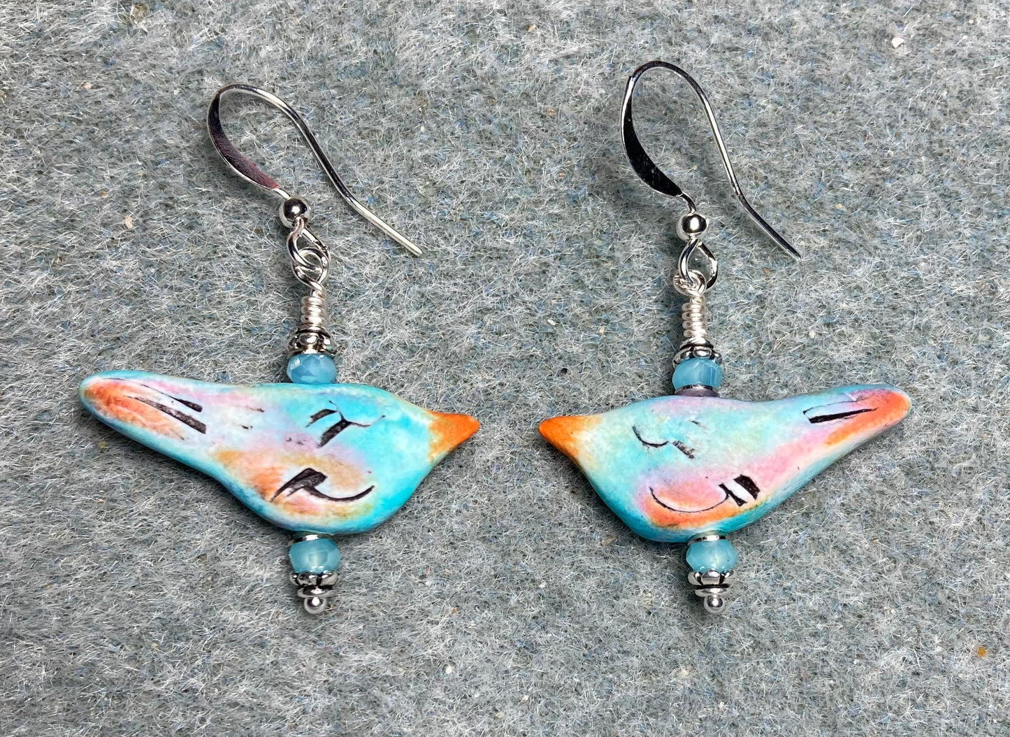 Small turquoise, peach, and orange polymer clay bird bead earrings adorned with turquoise Chinese crystal beads.