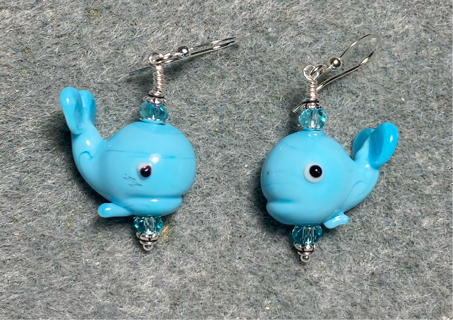 Turquoise lamp work whale bead earrings adorned with turquoise Chinese crystal beads.