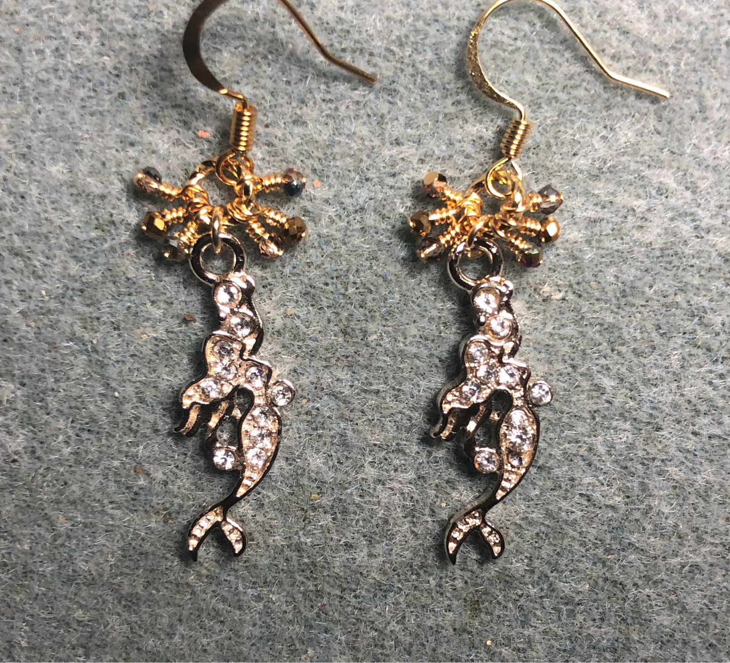 Gold and clear rhinestone mermaid charm earrings adorned with tiny dangling clear and gold Chinese crystal beads.