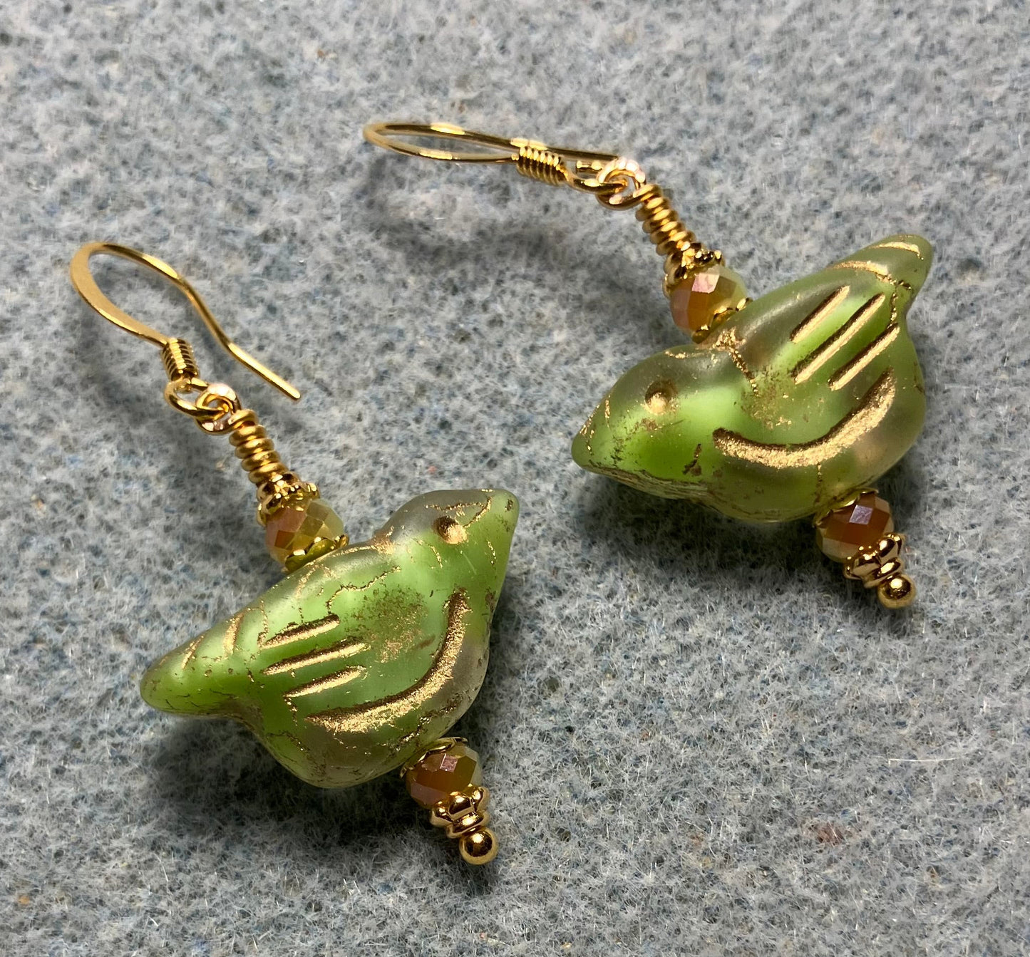 Lime green (with gold wash) Czech glass bird bead earrings adorned with lime green Chinese crystal beads.