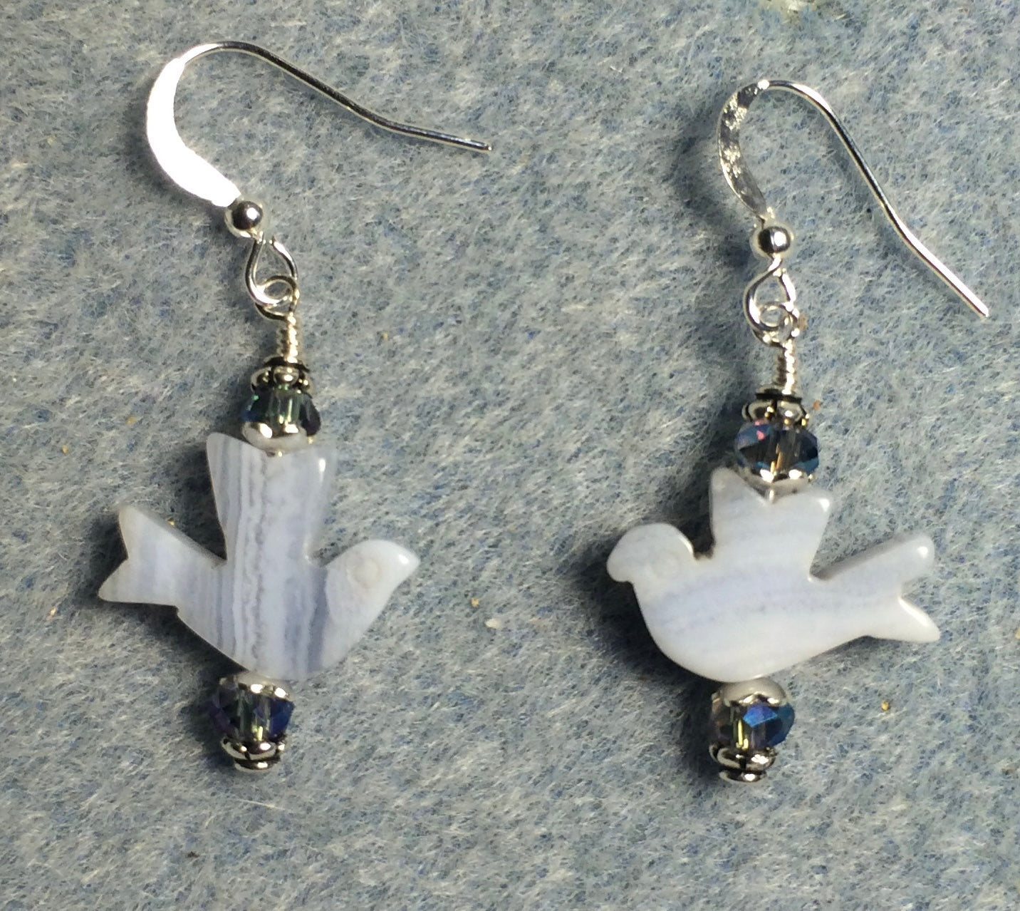 Blue lace agate gemstone flying dove bead earrings adorned with light blue Chinese crystal beads.