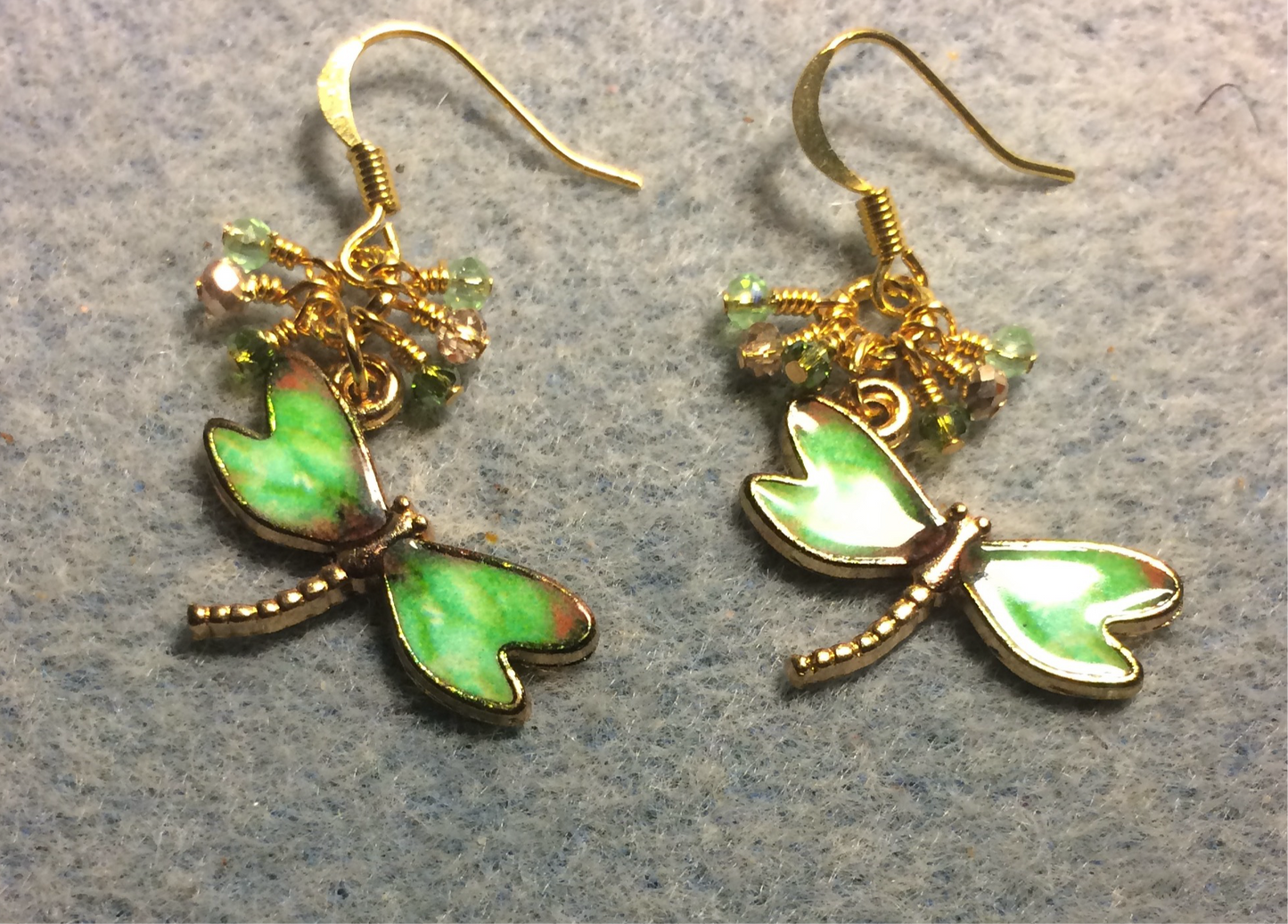 Apple green enamel dragonfly charm earrings adorned with tiny dangling apple green and gold Chinese crystal beads.