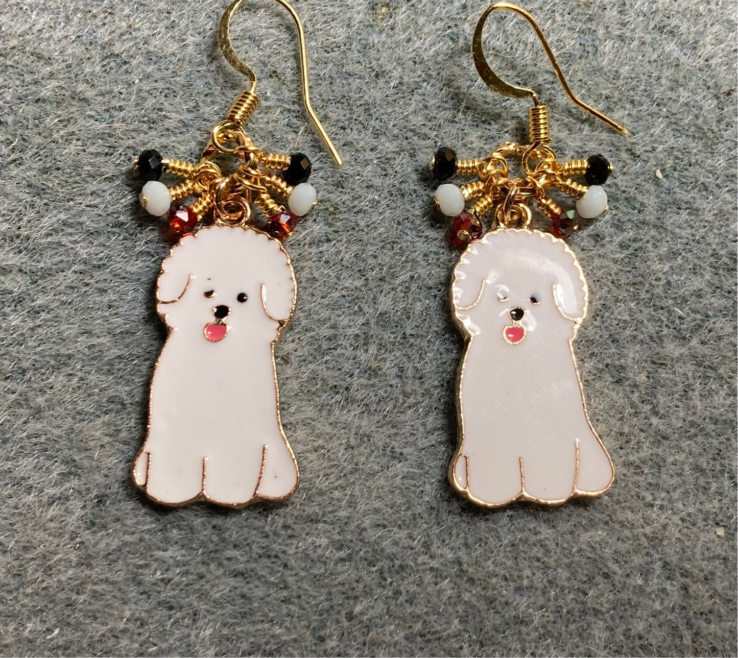 White enamel sheepdog charm earrings adorned with tiny dangling black, white, and red Chinese crystal beads.