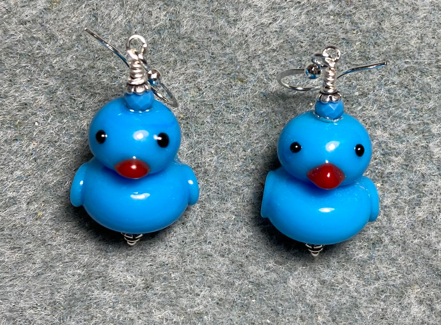Opaque blue lamp work duck bead earrings adorned with blue Chinese crystal beads.