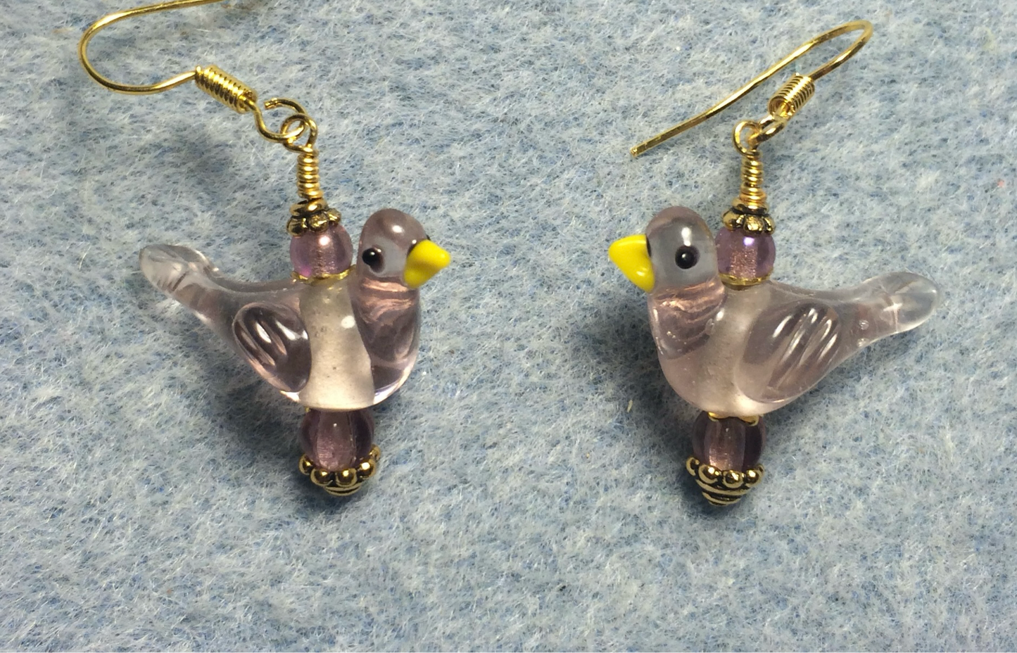Translucent violet lamp work songbird bead earrings adorned with violet Czech glass beads.