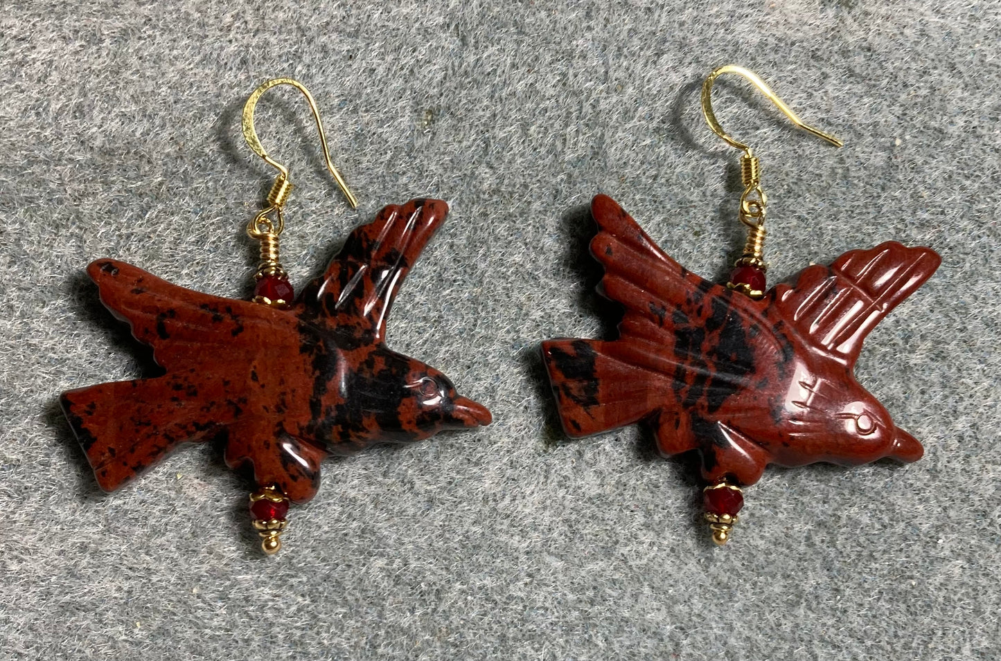 Large red poppy jasper gemstone flying eagle bead earrings adorned with dark red Chinese crystal beads.