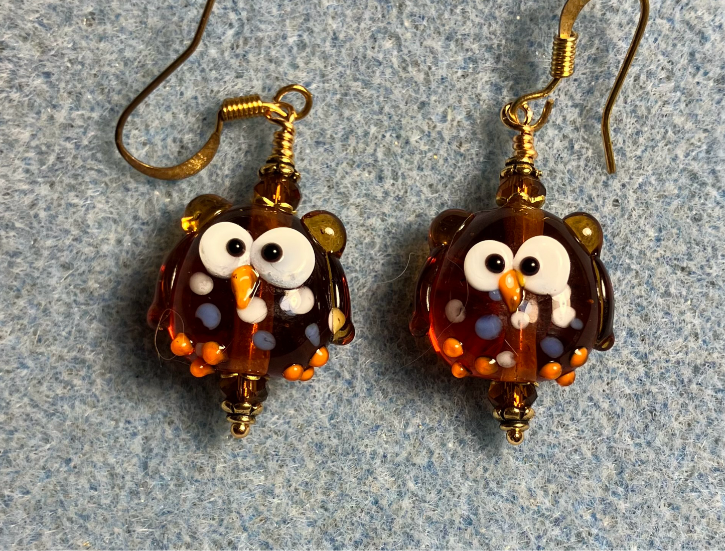Caramel colored lamp work spotted owl bead earrings adorned with caramel Chinese crystal beads.