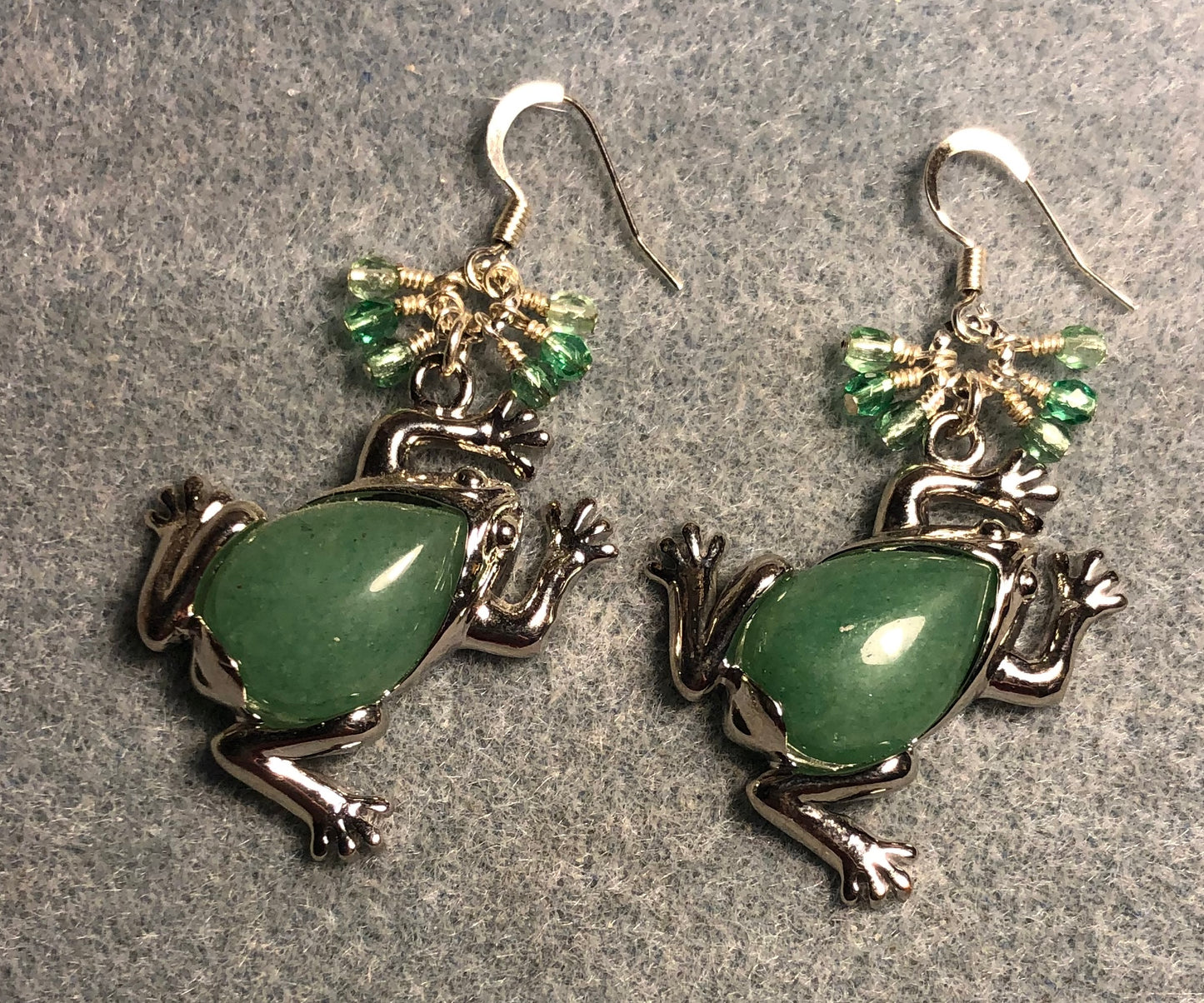 Large silver and green aventurine gemstone frog charm earrings adorned with small dangling green and silver Czech glass beads.