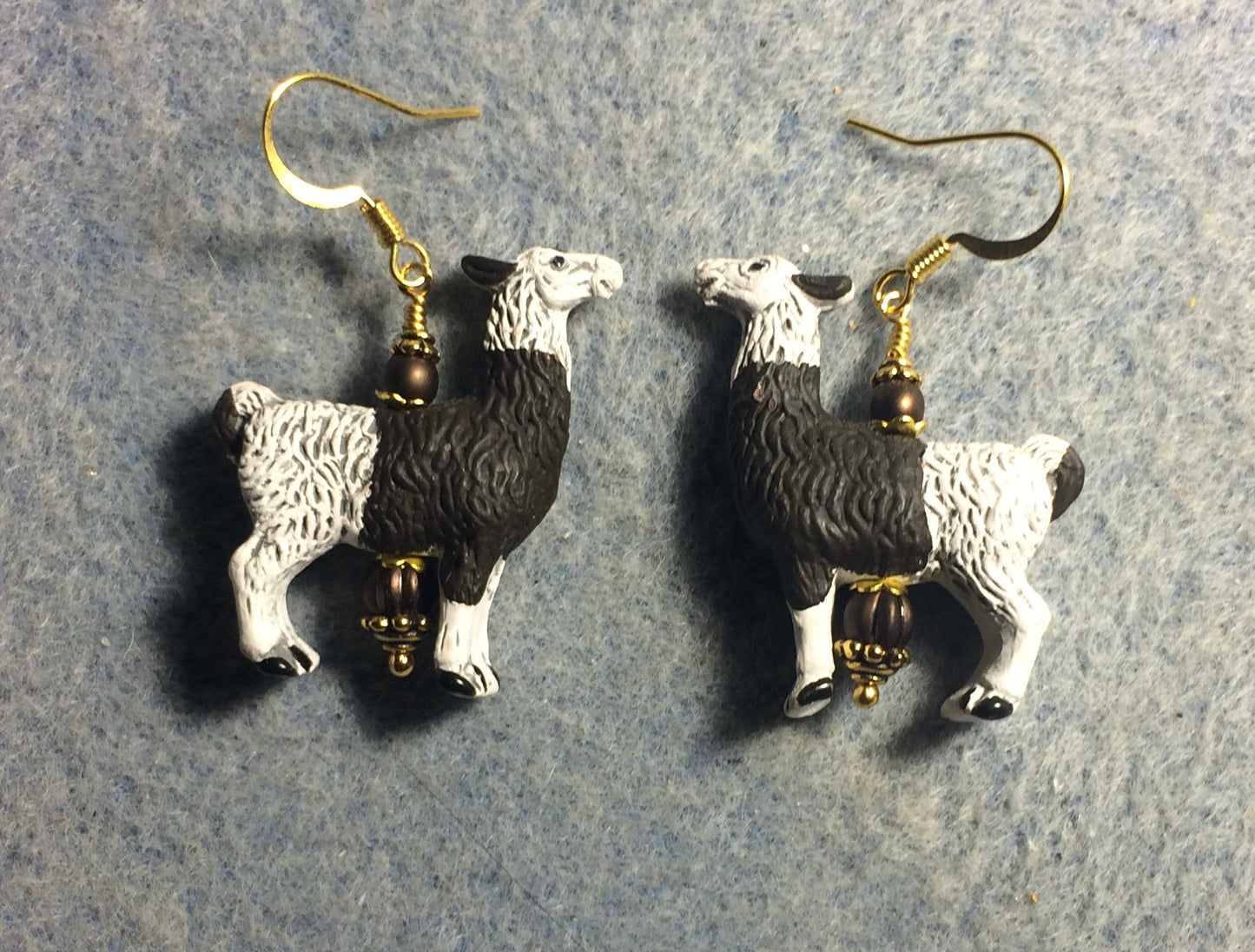 Large white and brown ceramic llama bead earrings adorned with brown Czech glass beads.