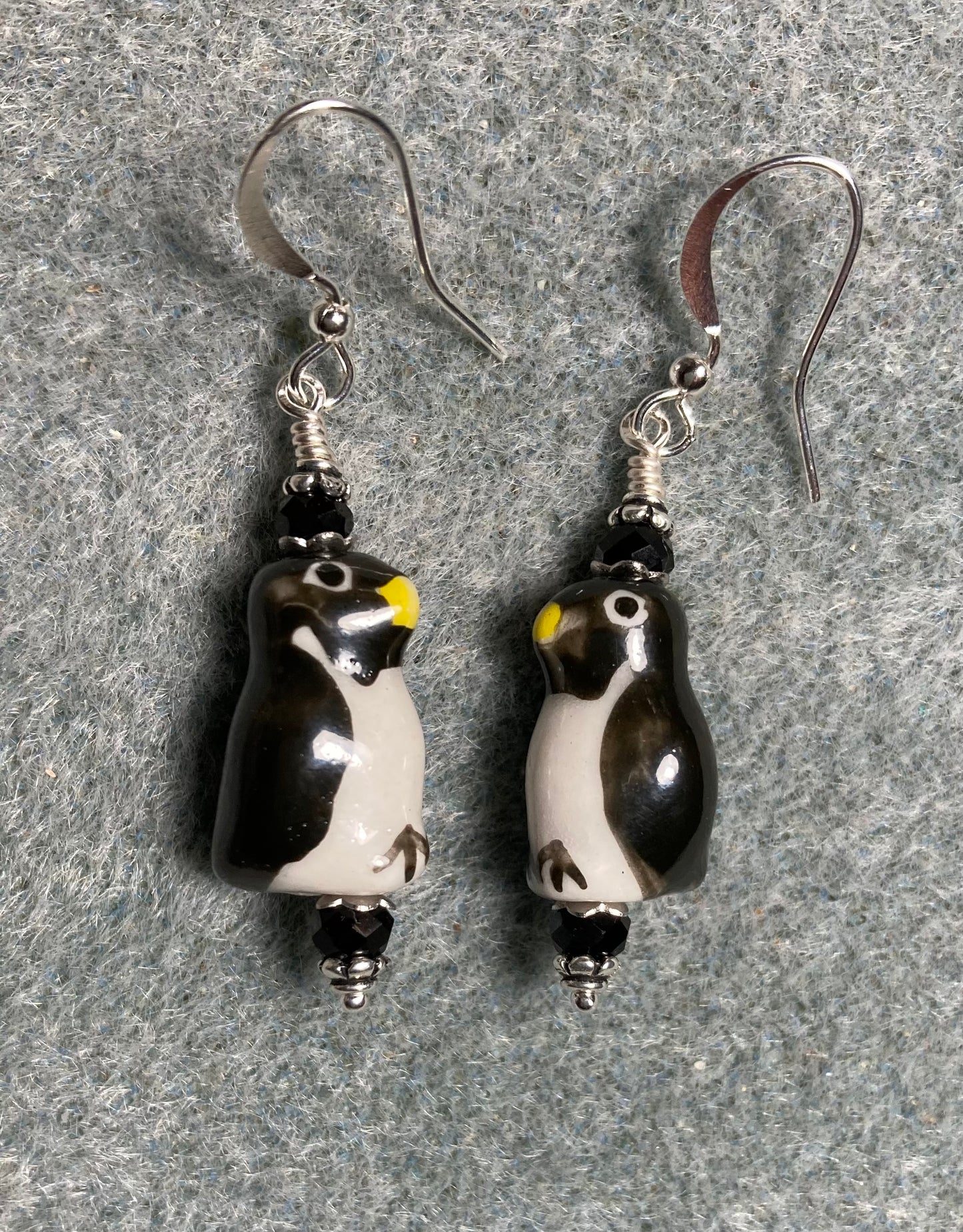 Black and white ceramic penguin bead earrings adorned with black Chinese crystal beads.