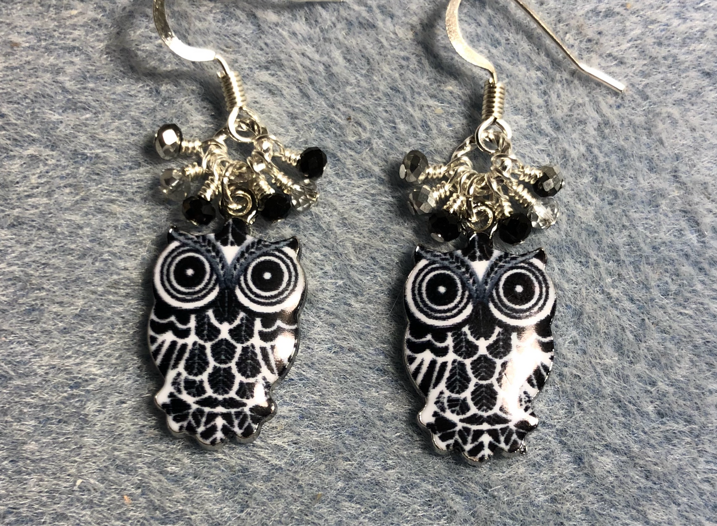 Black, white, and silver enamel owl charm earrings adorned with tiny dangling black and silver Chinese crystal beads.