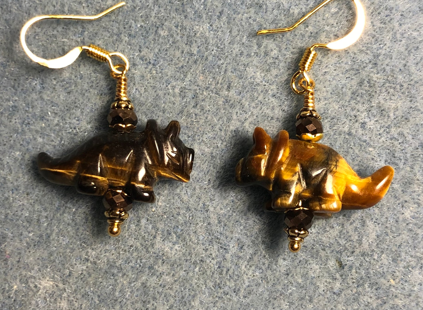 Brown tigereye gemstone dinosaur bead earrings adorned with brown Chinese crystal beads.