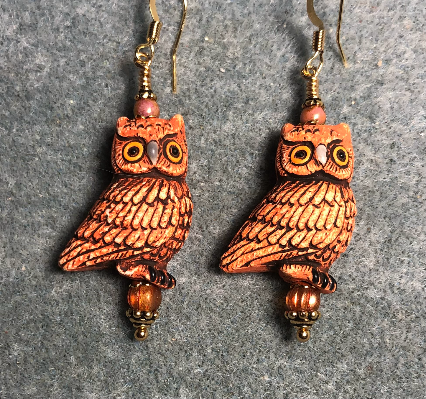 Orangish brown ceramic owl bead earrings adorned with orange Czech glass beads.