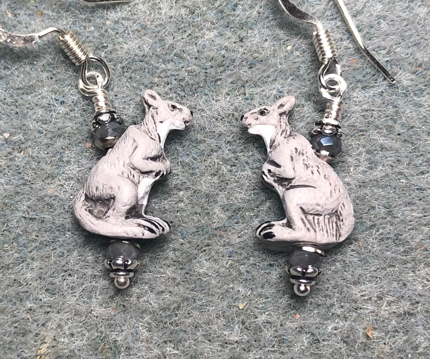 Tiny gray ceramic kangaroo bead earrings adorned with tiny gray Chinese crystal beads.