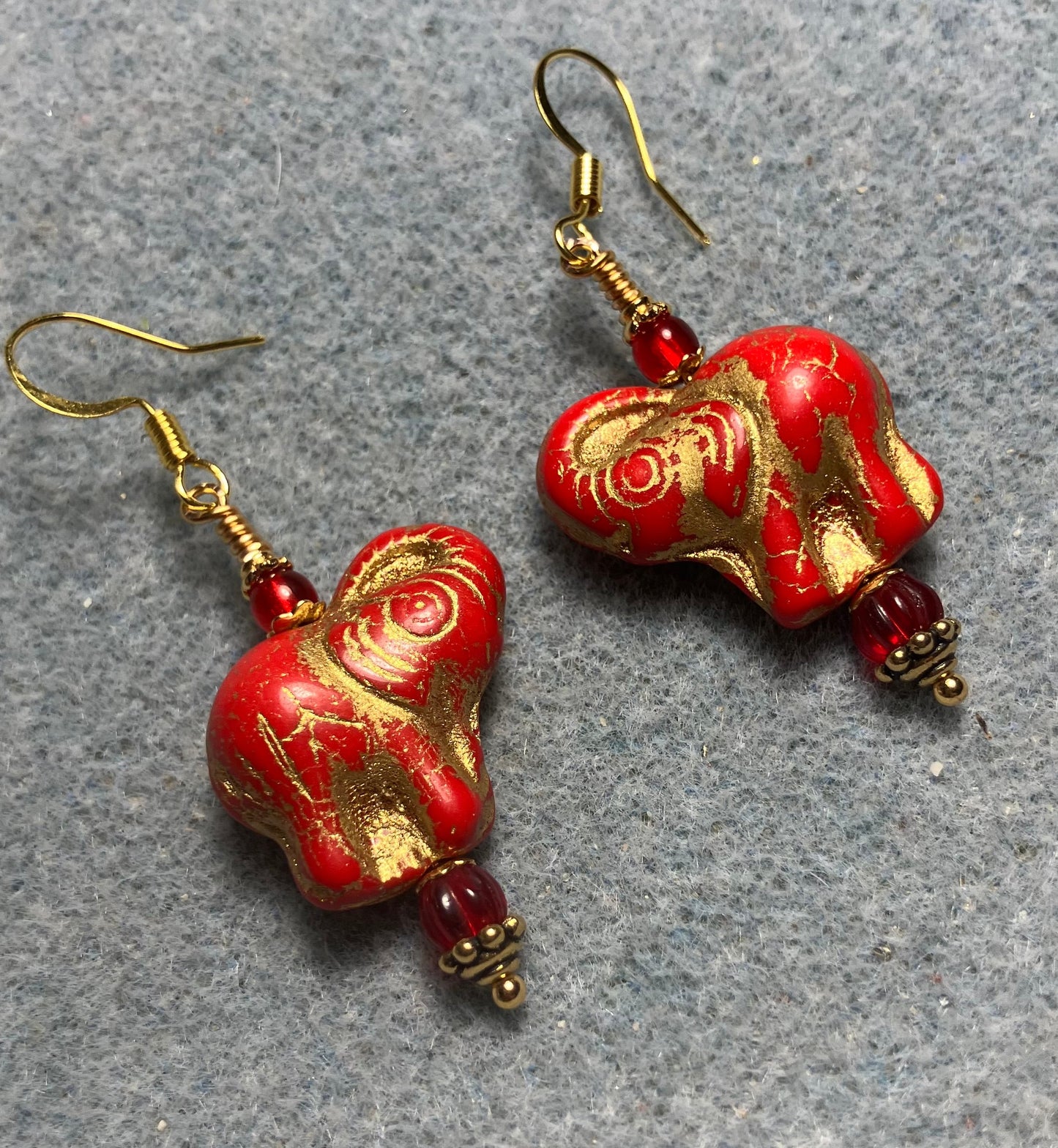 Bright red (with gold inlay) Czech glass elephant bead earrings adorned with red Czech glass beads.