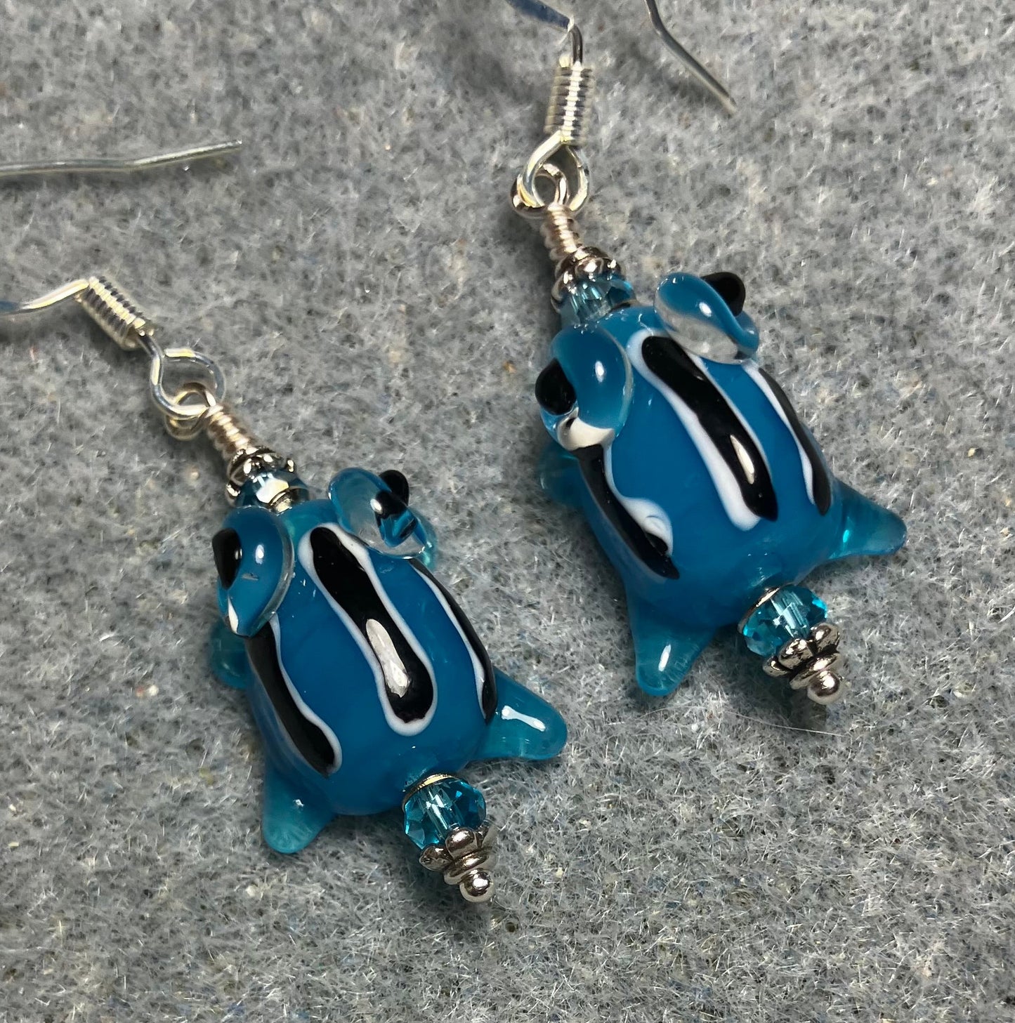 Very small turquoise with black stripes lamp work frog bead earrings adorned with turquoise Chinese crystal beads.