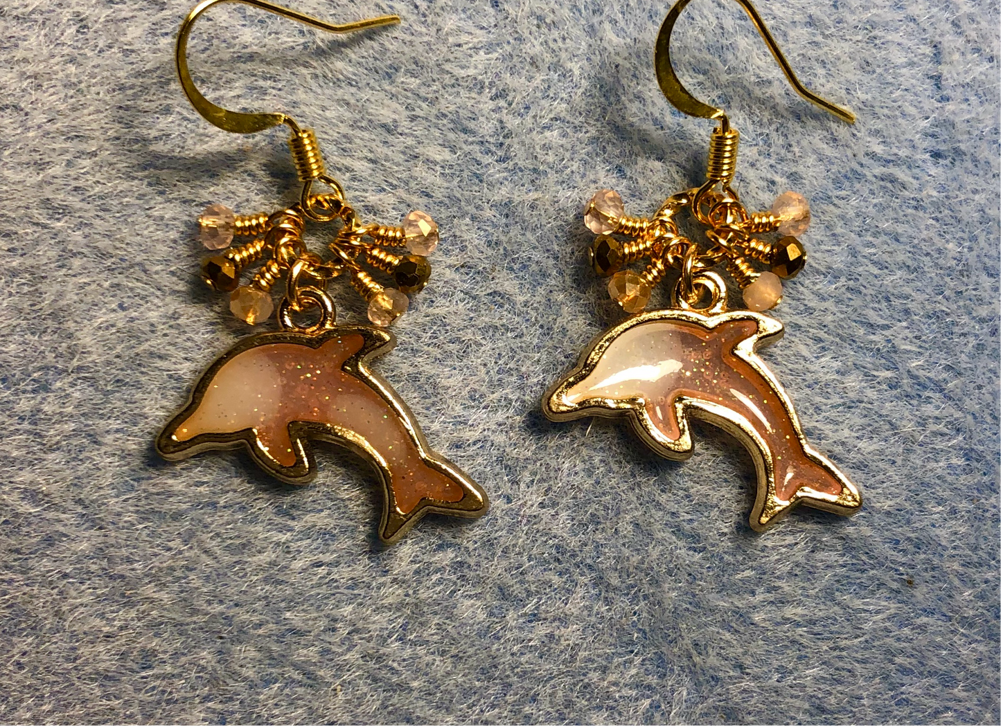 Peach and gold resin dolphin charm earrings adorned with tiny dangling peach and gold Chinese crystal beads.