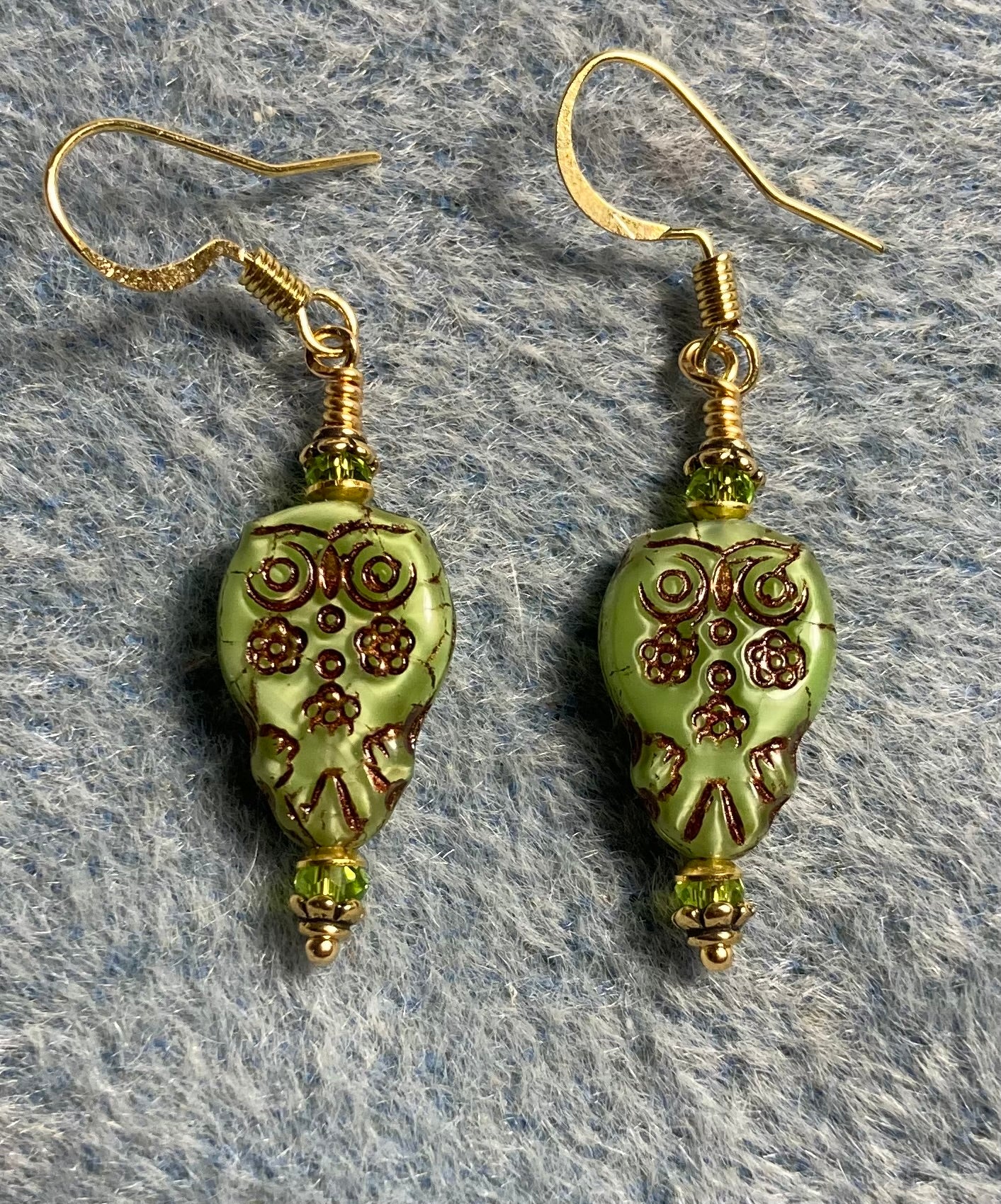 Small olive green Czech glass owl bead earrings adorned with small olive green Chinese crystal beads.