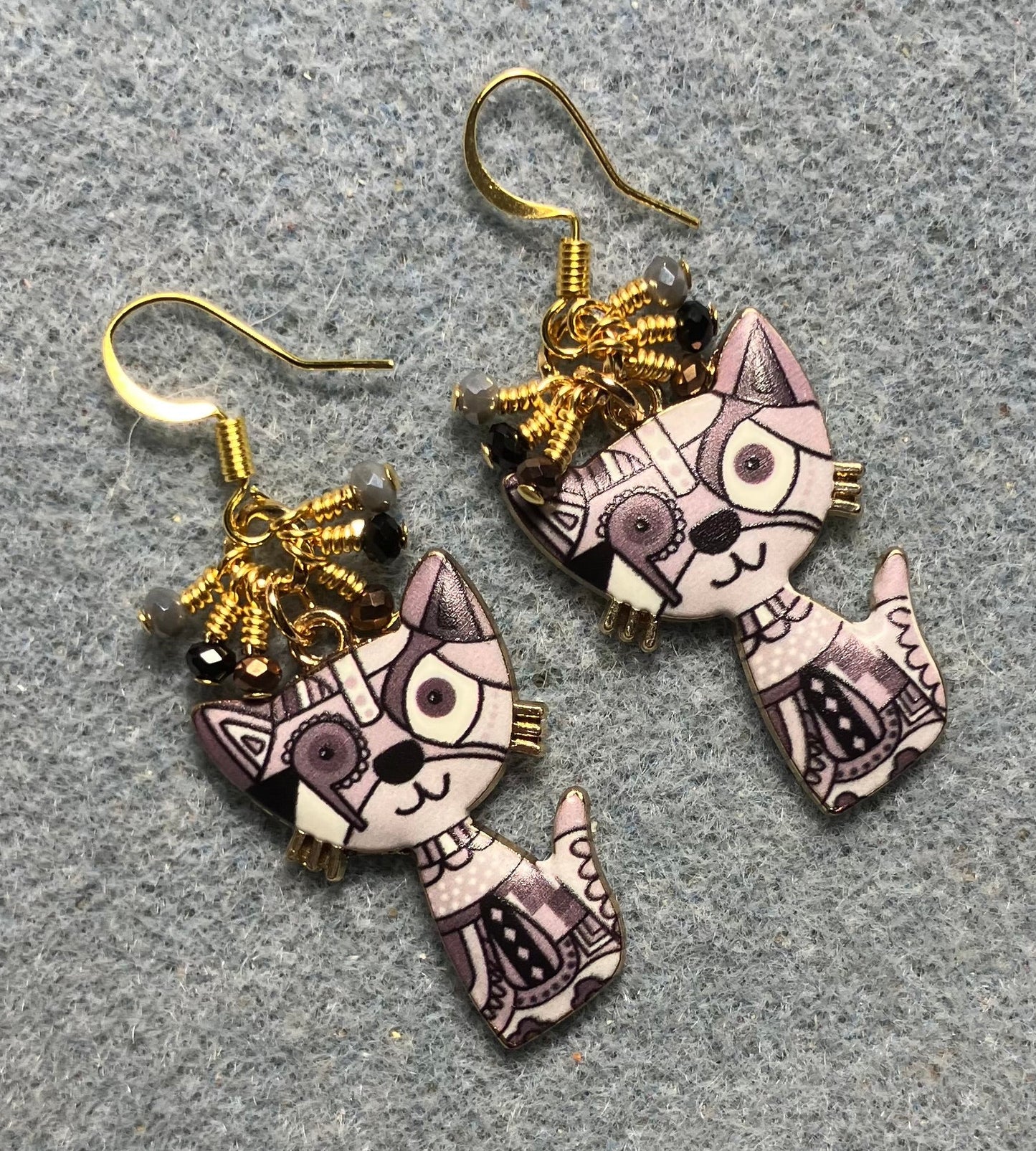 Brown, gray, and beige enamel cat charm earrings adorned with tiny dangling brown, black, and gray Chinese crystal beads.