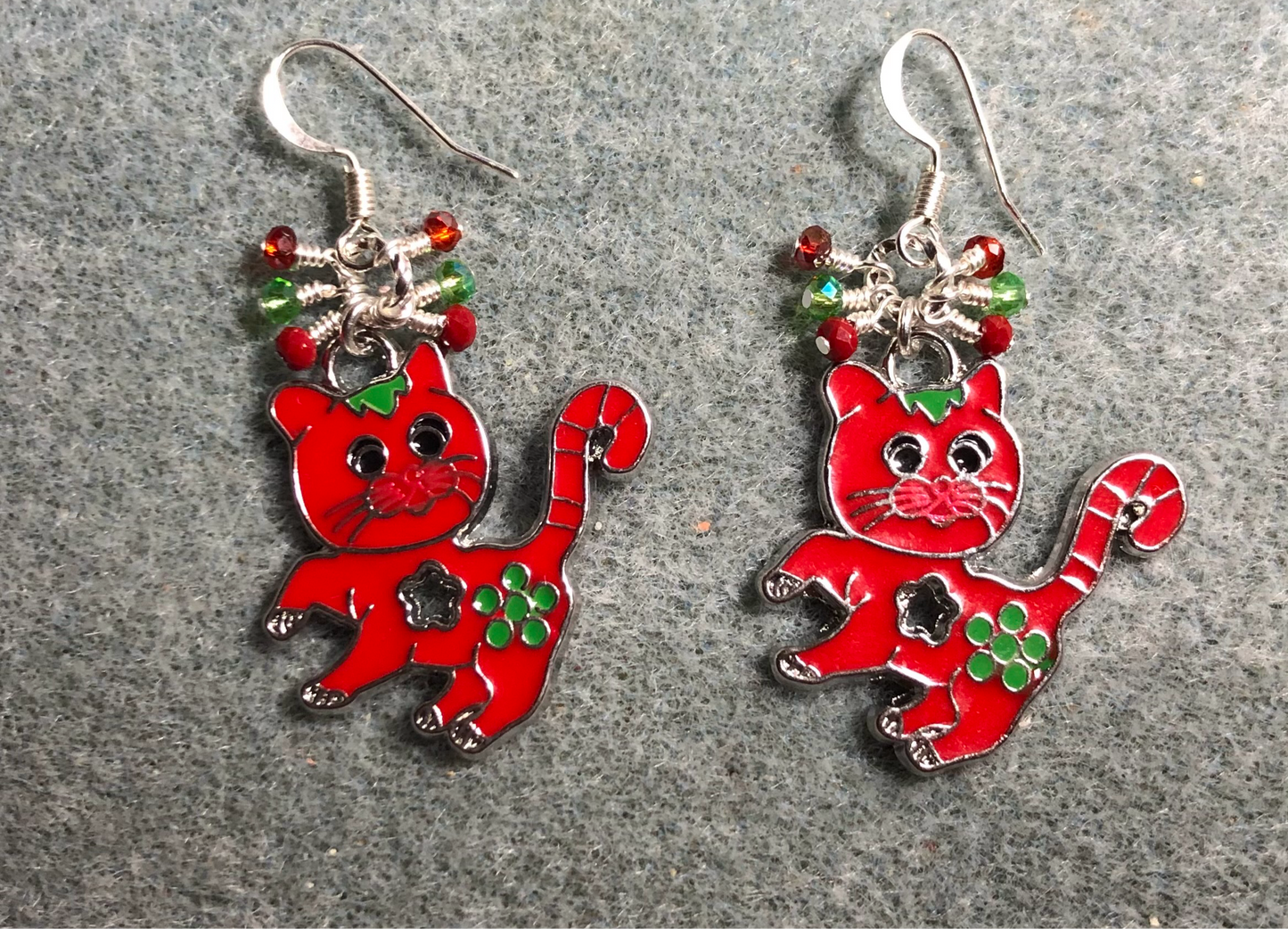 Red and green enamel cat charm earrings adorned with tiny dangling red and green Chinese crystal beads.