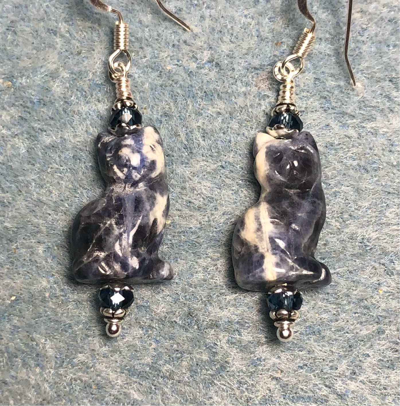 Blue sodalite gemstone cat bead earrings adorned with blue Czech glass beads.