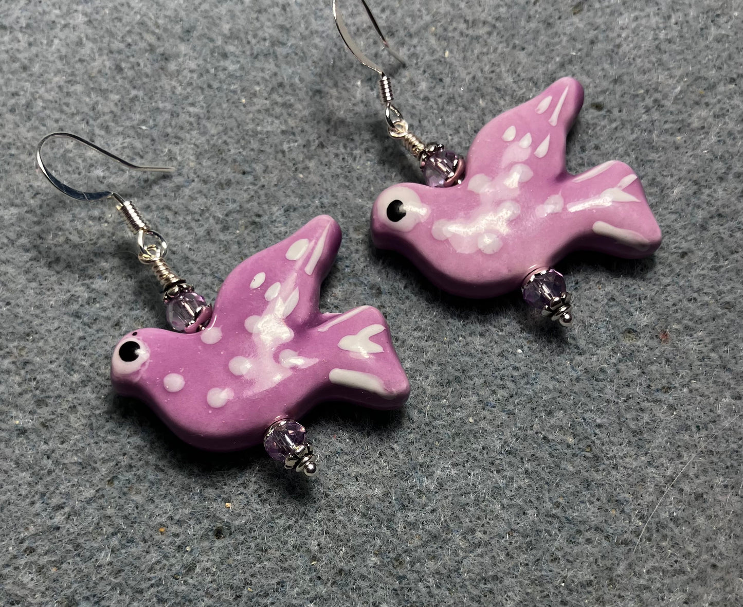 Large lavender ceramic flying dove bead earrings adorned with lavender Chinese crystal beads.