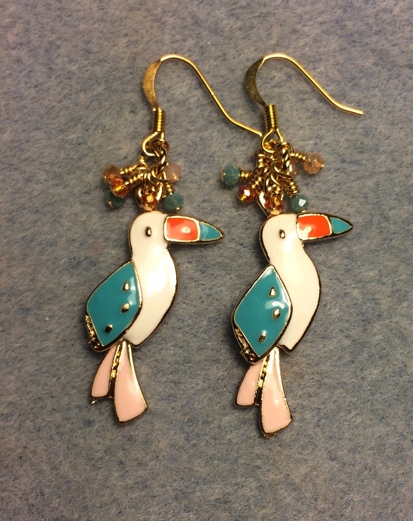 Peach, turquoise, and orange enamel toucan charm earrings adorned with tiny dangling peach, turquoise, and orange Chinese crystal beads.