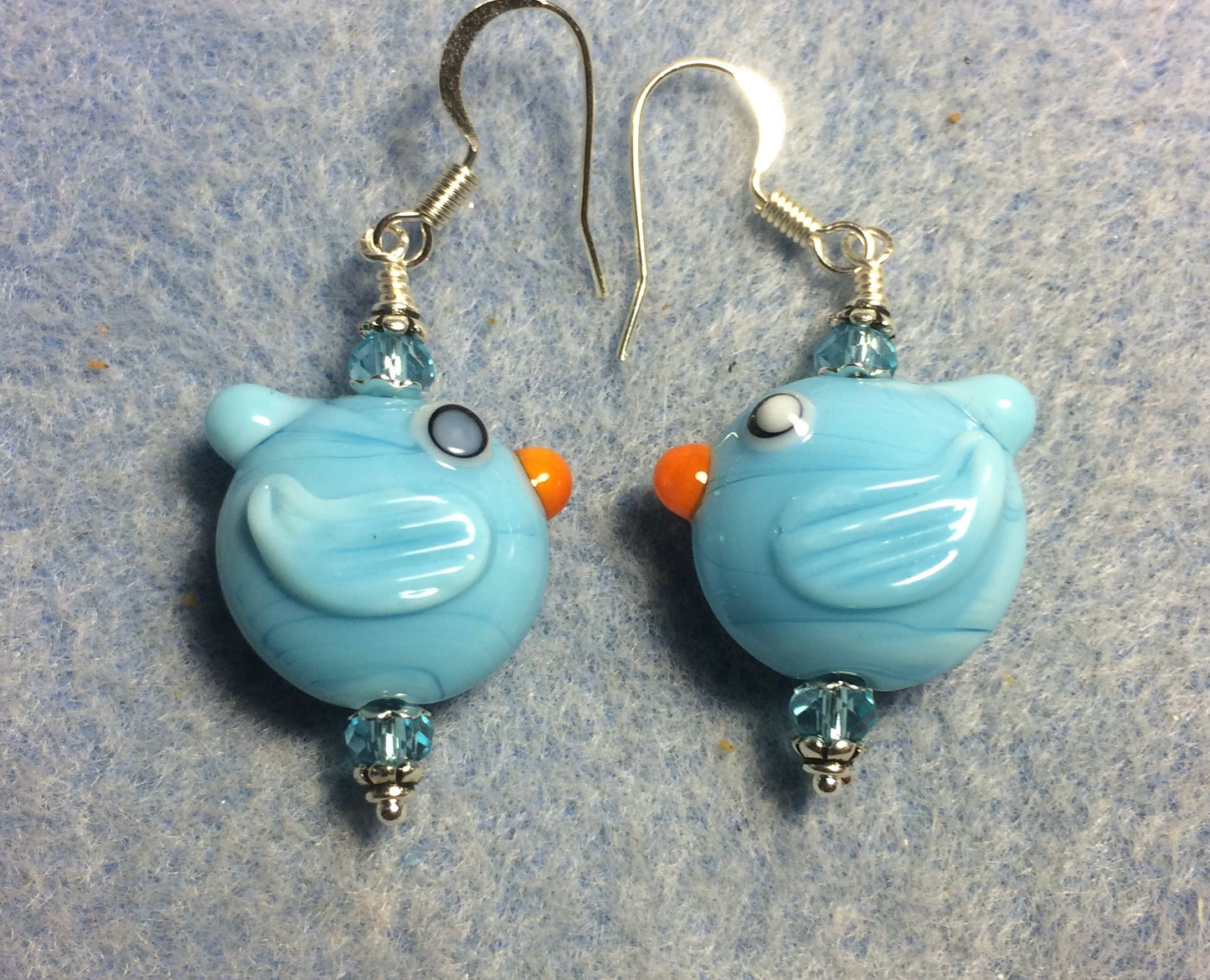 Light aqua lamp work bird bead earrings adorned with light aqua Chinese crystal beads.