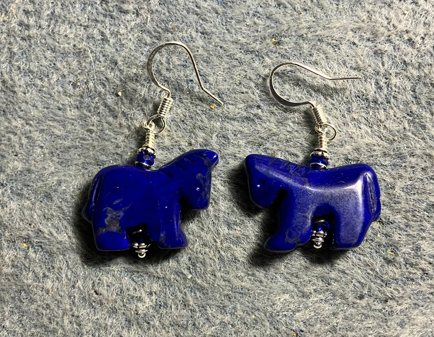 Blue lapis lazuli howlite horse bead earrings adorned with dark dark blue Chinese crystal beads.