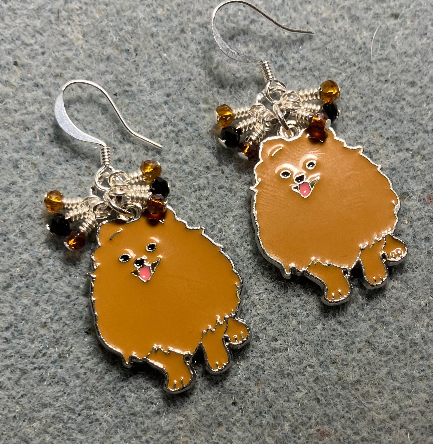 Brown enamel Pomeranian dog charm earrings adorned with tiny dangling brown, amber, and black Chinese crystal beads.