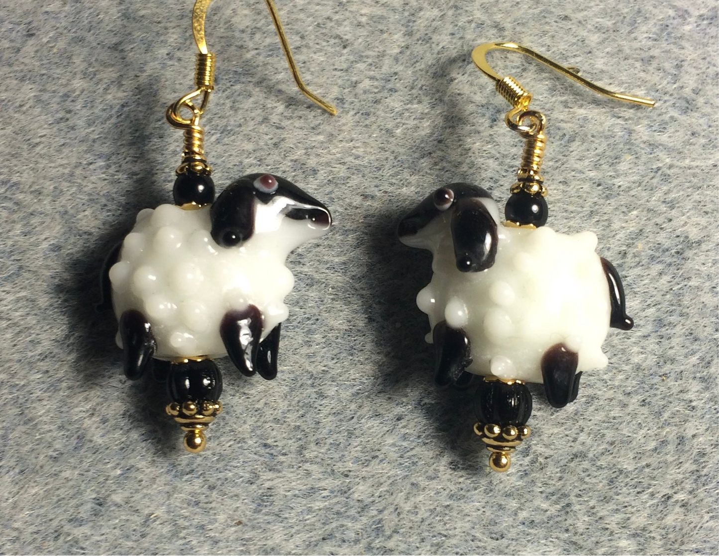White and black lamp work sheep bead earrings adorned with black Czech glass beads.