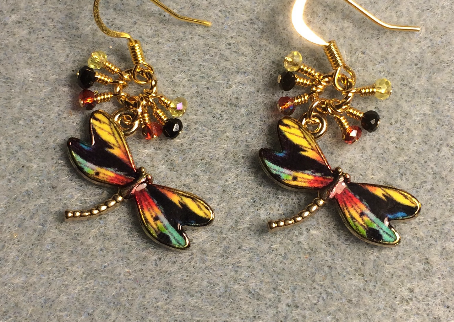 Black, yellow, and red enamel dragonfly charm earrings adorned with tiny dangling black, yellow, and red Chinese crystal beads.