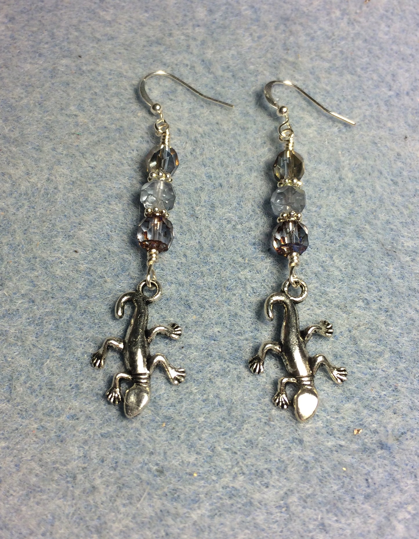 Silver lizard charm earrings adorned with light blue Czech glass beads
