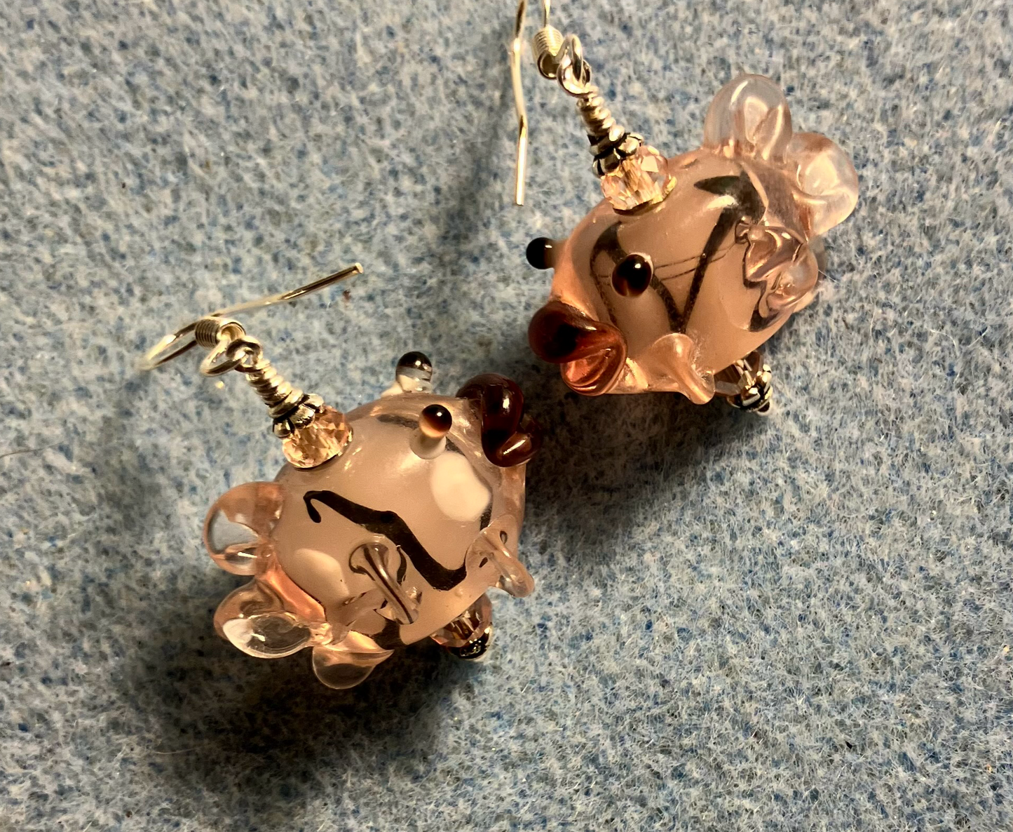 Pink and black lamp work kissing fish bead earrings adorned with pink Chinese crystal beads.